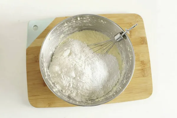 Stir, add flour and baking powder.