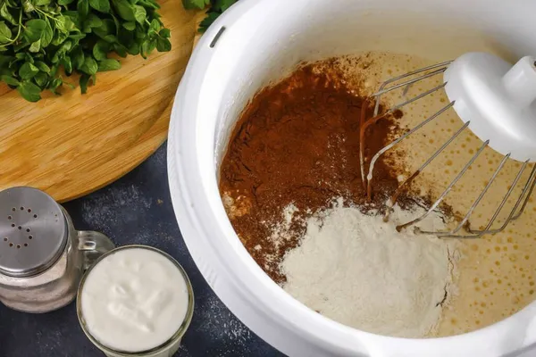 Then add 3 tablespoons to the egg mass. powdered cocoa and wheat flour. Use a silicone spatula or whisk to gently stir in the dry ingredients.