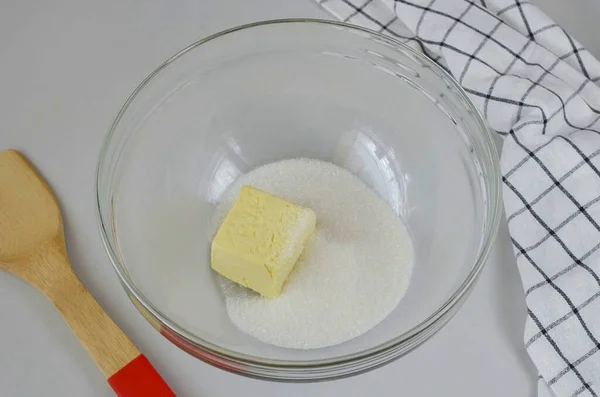 The butter should be at room temperature, soft. Add sugar to it and beat with a mixer until smooth.