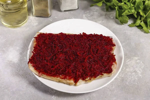 Lay out the grated beets and smooth them over the surface of the fish pieces. Cover with cling film, leaving small openings for air. Place in the refrigerator overnight. Remember, if the slices are thin, it is best to remove the beets after about 4-5