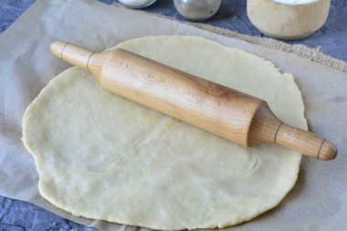 Roll out the dough into a circle with a thickness of 0.4-0.5 cm.