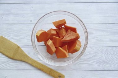 Wash the pumpkin, peel, cut into pieces. Transfer to a heat-resistant dish.