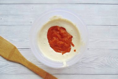 Add semolina and blended pumpkin to the whipped curd mixture.