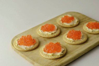 Place the caviar on top of the cracker.
