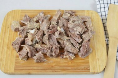 Cut it into pieces. Return to broth.