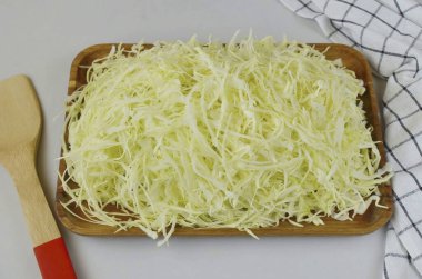 Remove the top leaves from the cabbage, remove the stalk. Chop the cabbage thinly with a sharp knife or shredder.