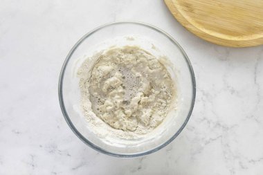 Bir bardak su dök. Sodayı sirkeyle söndürün. Hamura ekle, her şeyi karıştır..