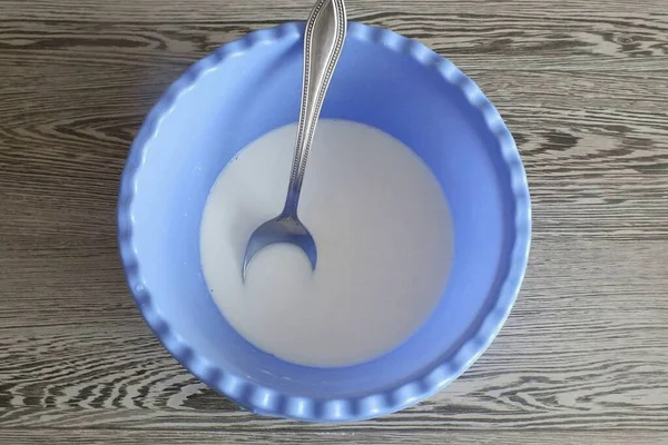 In a bowl, mix warm milk, water and yeast.