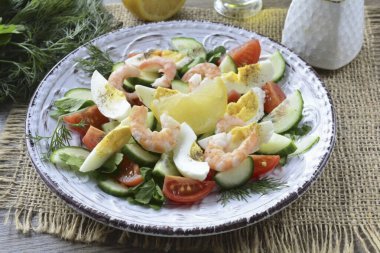 Soğutulmuş karidesleri soy, salataya koy. Tabağı limon suyuyla doldur, zeytinyağı. Hafif tuzlu ve biberli salata. Hazır!.