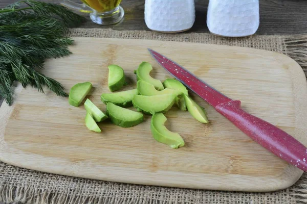 Remove the avocado pulp with a spoon and cut into strips.