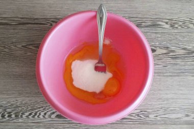 Hamuru hazırla. Bir kasede, yumurtaları şeker ve vanilyayla karıştır..