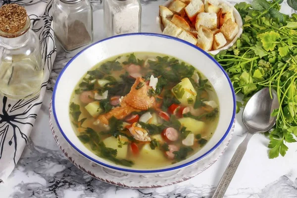 Pour the hot soup into deep bowls and serve with croutons or croutons. Fragrant soup with smoked meats will perfectly warm you at lunchtime in the winter cold and give you strength for further achievements.