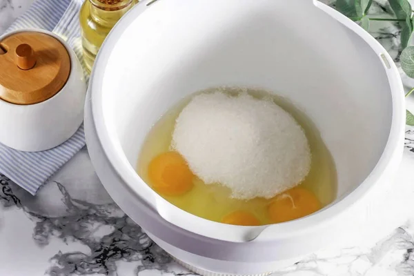 In the bowl of a stand mixer or food processor, beat the eggs, sugar, and salt until fluffy, about 3 to 5 minutes.