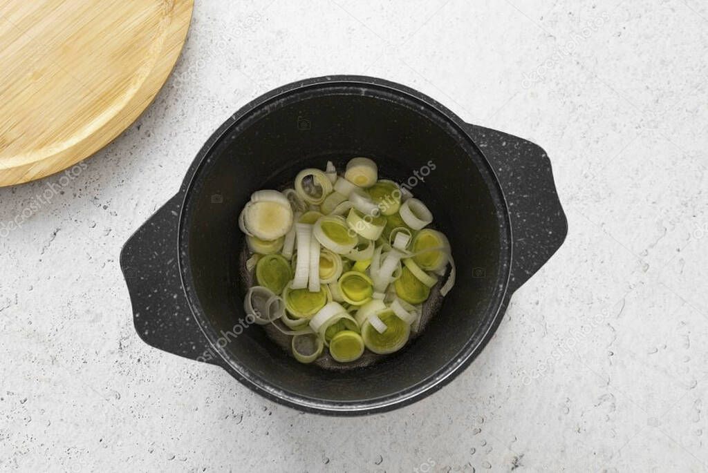 Heat a heavy bottomed saucepan over medium heat. Melt butter and olive oil there. Add the sliced white part of the leek. Fry it for about 3 minutes