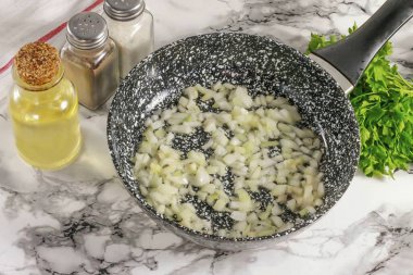 Soğanın yarısını küçük küplere ayırın ve tavada kızarana kadar sebze yağıyla sotelenin..