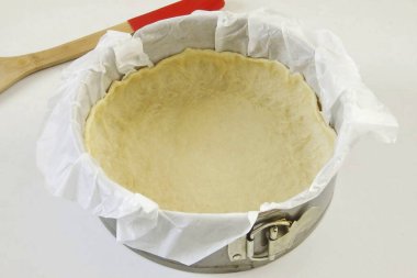 Formu parşömen kağıdıyla, yağı yağ ile kaplayın. Hamuru biraz dışarı çıkar ve yüksek kenarları oluşturacak şekilde dağıt (Çapı 20 cm olan bir formum var).