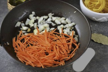 Köfteleri bir tabağa koy ve doğranmış soğanları ve havuçları aynı yağda koy. Yumuşayana kadar 3 dakika sote sebze..