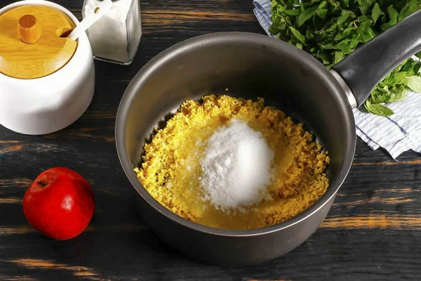 stock image Pour the washed cereal into a cauldron or ladle, a pan with a non-stick bottom. Add salt and sugar. Pour in warm water and boil for about 10 minutes, removing the resulting foam, there will be a lot of it.