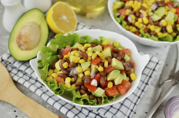 A simple and colorful bean and corn salad is made with just a few ingredients. Beans go great with corn, while tomato and avocado refresh the dish. Good appetite!