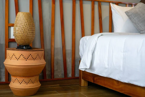Bamboo Bed Lamp on Ceramic Bed Side Table next to a Bed with Woo