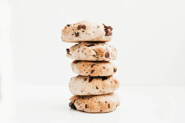Stack of homemade vegan chocolate chip cookies on white backgrou