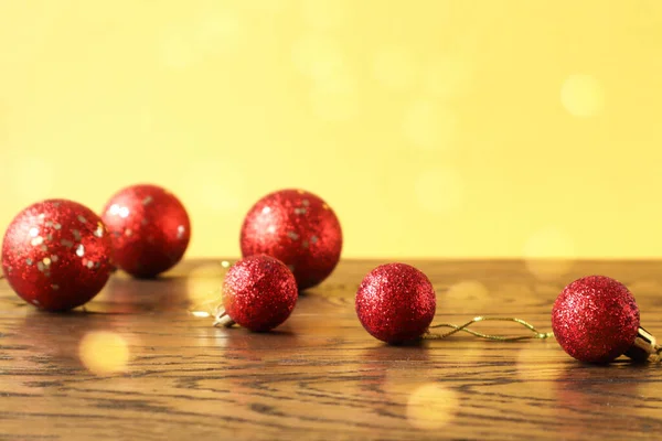 Χριστούγεννα Φόντο Κόκκινο Μπάλες Χριστούγεννα Ένα Ξύλινο Τραπέζι Κίτρινο Φόντο — Φωτογραφία Αρχείου