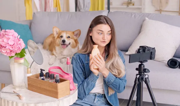 A Young Woman, a Beauty Blogger Shoots Her Video Blog about Beauty. Review of Cosmetics Live at Home. Influential Freelancer. Next Generation of Beauty Influencers
