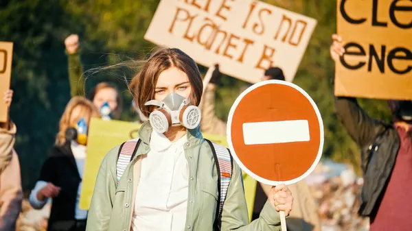 (Inggris) Portrait of Attractive Young Woman Activist Holding Stop Sign. Stok Foto Bebas Royalti