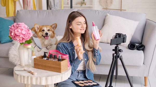 A Young Woman, a Beauty Blogger Shoots Her Video Blog about Beauty. 가정에서 일어나는 화장품에 대한 연구. 아름다움의 다음 세대가 영향을 미치다 스톡 이미지