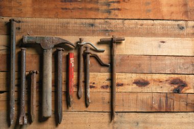 Various masonry hand tools on a rustic wooden