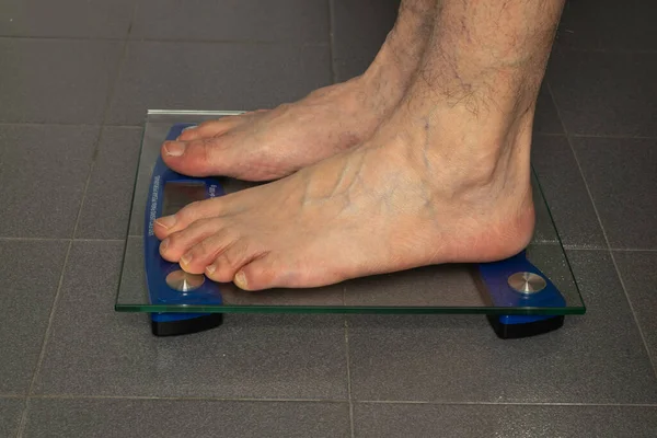 Feet sideways on a scale