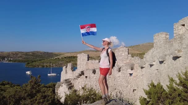 Женщина, размахивающая хорватским флагом на стене Страусы — стоковое видео