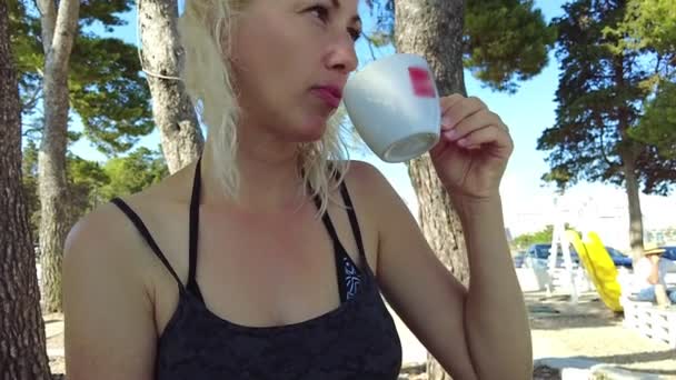Woman with coffee in Zadar beach in Croatia — Stock Video