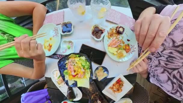 Aerial View Table Couple Eating Chopsticks Picking Uramaki Salmon Sashimi — Stock videók