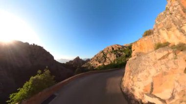 Aerial drone view of the Piana Badlands of Corsica on the D81 route at sunset. Les Calanques of Piana natural park in Mediterranean sea by the Porto Ota town. 360 view of UNESCO heritage