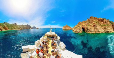 Corsica, France - June 2022: Touristic tour from Porto Ota to badlands Calanques of Piana. Aerial view on cruise ship with tourists and badlands called Les Calanques in Mediterranean sea. 360 degrees clipart