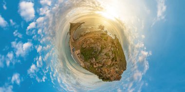 Tiny Planet top view of a tourist woman hiker on top in Punta Parata by the Sanguinaires islands. Sunset aerial view of Parata tower in Corsica island of France. 360 degrees panorama.