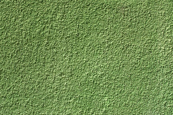 Pared pintada con textura rugosa en primer plano. Yeso verde con textura cepillada, pared de la casa, espacio para copiar —  Fotos de Stock