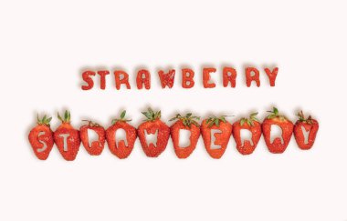 Beyaz arka planda taze çilekten kesilmiş mektuplar. Düz yatay bileşim, sağlıklı besin konsepti