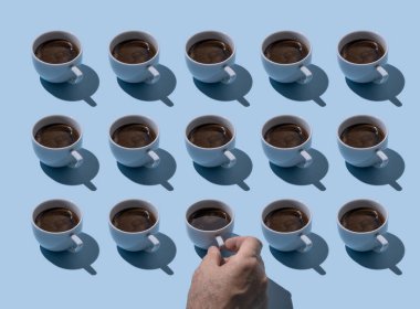 Male hand takes one of coffe cups in a rows on blue gray background. Seamless pattern, minimal morning workimg day start motivation concept