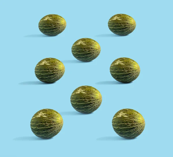 Honeydew melons on a blue background. Minimal composition, seamless pattern, healthy sweet food concept