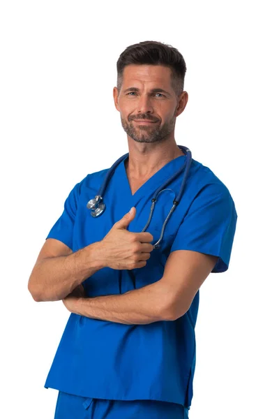 身穿蓝色制服的男护士 带听诊器站着 大拇指在白色背景上被隔离 — 图库照片