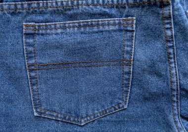 Back pocket of classic jeans. Close-up.