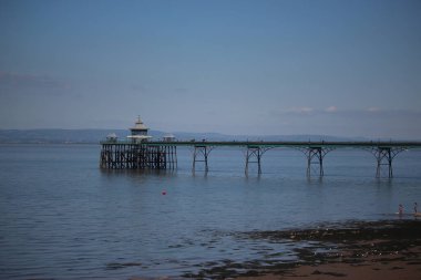 Clevedon pier putside of Bristol in South West England under the scorching sun on a clear summers day as the river servern lazily flows by