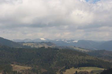Sweeping views over the tree lined and occasionally snowy valleys and hills of the Black forest around Badenweiler in southern Germany near the border with Switzerland at the heart of Europe
