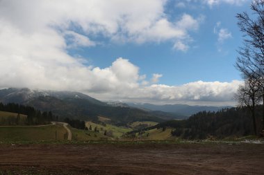 Sweeping views over the tree lined and occasionally snowy valleys and hills of the Black forest around Badenweiler in southern Germany near the border with Switzerland at the heart of Europe