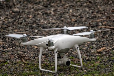 Yerden kalkan beyaz bir dron kuadkopteri. Yumuşak odaklanma. Hareket bulanıklığı.