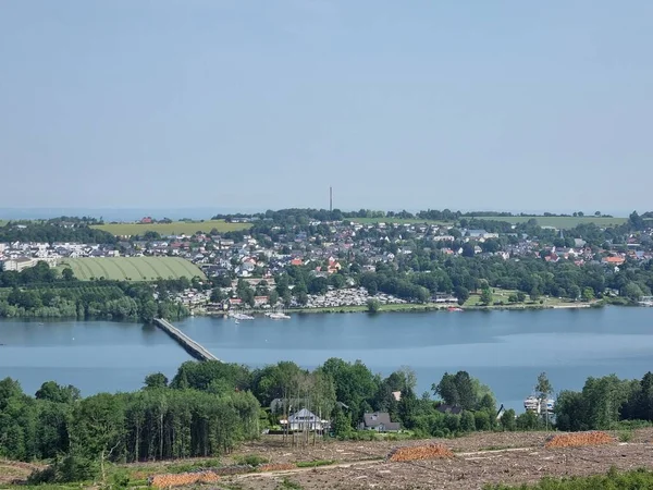 View from the Moehne Lake tower to the Moehne Lake, North Rhine-Westphalia, Germany, on the left the pedestrian bridge over the lake, opposite Koerbecke, the main town of the municipality of Moehnesee