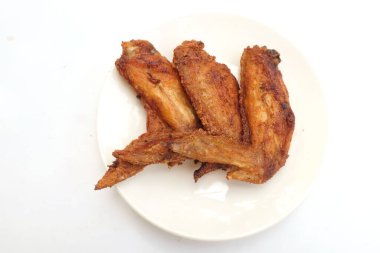 close up a fried chicken wings in white dish isolate on a white bsckground