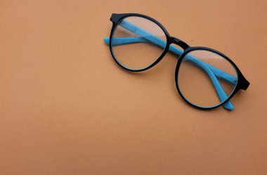 Clear eyeglasses, Glasses blue frame with wire strip modern style on brown background